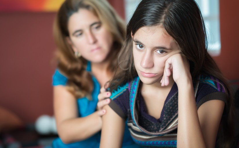 Teenager problems - Mother comforts her troubled teenage daughter